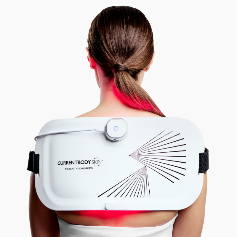 CurrentBody LED Light Therapy Panel on woman's back for pain relief and skin treatment